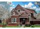 Charming two-story brick home with colorful shingles and a well-maintained front yard, showcasing curb appeal at 2927 N Humboldt St, Denver, CO 80205