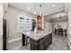 Spacious kitchen featuring a large island with seating, and views of the dining and entryway at 2927 N Humboldt St, Denver, CO 80205