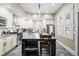 Modern kitchen with stainless steel appliances, large island, granite countertops, and white cabinetry at 2927 N Humboldt St, Denver, CO 80205