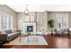 Elegant living room featuring hardwood floors, a fireplace, neutral decor, and plenty of natural light at 2927 N Humboldt St, Denver, CO 80205