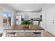 Bright dining area and kitchen featuring white cabinets, a center island, and stainless steel appliances at 610 Mosquito St, Elizabeth, CO 80107