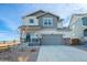 Charming two-story home with landscaped yard, two car garage and covered front porch on a bright day at 610 Mosquito St, Elizabeth, CO 80107