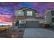 Charming two-story home with landscaped yard, two car garage and covered front porch with beautiful sunset at 610 Mosquito St, Elizabeth, CO 80107