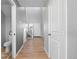 Well-lit hallway with hardwood floors, staircase, and a view of the front door at 610 Mosquito St, Elizabeth, CO 80107