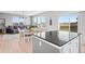Kitchen featuring a gray island with seating, seamlessly integrated into the open-concept dining and living area at 610 Mosquito St, Elizabeth, CO 80107