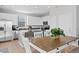 Bright kitchen and dining area featuring white cabinets, a center island, and stainless steel appliances at 610 Mosquito St, Elizabeth, CO 80107