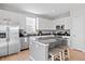 Modern kitchen with stainless steel appliances, island with seating, and stylish gray countertops at 610 Mosquito St, Elizabeth, CO 80107