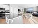 Modern kitchen with a gray island countertop, stainless steel appliances, and a view into the dining and living room at 610 Mosquito St, Elizabeth, CO 80107