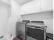 Efficient laundry room with modern washer and dryer, upper cabinets, and ample space at 610 Mosquito St, Elizabeth, CO 80107