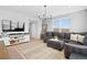 Comfortable living room with modern entertainment center, large windows, and neutral color palette at 610 Mosquito St, Elizabeth, CO 80107