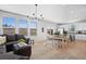 Open-concept living area with modern lighting, large windows, and combined kitchen and dining area at 610 Mosquito St, Elizabeth, CO 80107