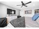 Comfortable main bedroom featuring a ceiling fan, mirror, dresser, and a flatscreen TV at 610 Mosquito St, Elizabeth, CO 80107