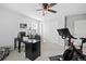 Bright office with a closet, ceiling fan, black desk, and stationary bike for home fitness at 610 Mosquito St, Elizabeth, CO 80107