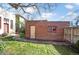 A brick garage in a backyard, with grassy areas and a stone pathway at 461 N Marion St, Denver, CO 80218