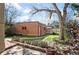 Backyard featuring a brick building, grassy areas, a brick patio, and mature landscaping at 461 N Marion St, Denver, CO 80218