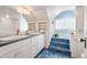 Elegant bathroom with a large tub with blue tiling and and sinks at 461 N Marion St, Denver, CO 80218