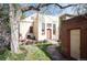 Charming brick house with mature trees, a quaint yard, and a stone pathway leading to the entrance at 461 N Marion St, Denver, CO 80218