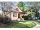 Charming brick home with a cozy front porch and a well-manicured lawn with mature trees at 461 N Marion St, Denver, CO 80218