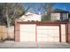 Spacious two-car garage with a large door, brick detailing, and a side entrance from the street at 461 N Marion St, Denver, CO 80218