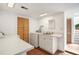 Bright laundry room featuring white appliances, ample counter space, and a sink with storage underneath at 461 N Marion St, Denver, CO 80218