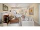 Bright living room with a fireplace, large windows, and an open layout to the dining area at 461 N Marion St, Denver, CO 80218