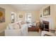 Bright living room with a decorative fireplace, neutral colored walls, and white sofa at 461 N Marion St, Denver, CO 80218
