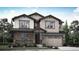 Charming two-story home featuring a stone-accented facade and a spacious two-car garage at 7436 S Yank Ct, Littleton, CO 80127
