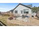 Outdoor patio with seating, grill, and fire pit, perfect for entertaining and enjoying the backyard at 19602 E 63Rd Dr, Aurora, CO 80019