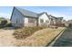 View of the house from the yard showing a stone facade and a green lawn on a sunny day at 19602 E 63Rd Dr, Aurora, CO 80019