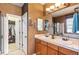Bright bathroom features a double sink vanity and a walk-in closet for ample storage at 19602 E 63Rd Dr, Aurora, CO 80019