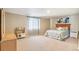 Bedroom featuring a play kitchen, window, a queen-size bed, and generous carpeted floor space at 19602 E 63Rd Dr, Aurora, CO 80019