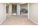 Large bonus room area with carpet and access to adjacent rooms and staircase at 19602 E 63Rd Dr, Aurora, CO 80019