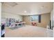 Expansive bonus room is well-lit and features a window with neighborhood views, perfect for hobbies at 19602 E 63Rd Dr, Aurora, CO 80019