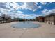 Community pool secured with a winter cover with a community building in the background at 19602 E 63Rd Dr, Aurora, CO 80019