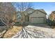 Charming two-story home featuring a two-car garage and mature trees at 19602 E 63Rd Dr, Aurora, CO 80019