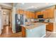 Kitchen features stainless steel appliances, granite counters, hardwood floors and ample cabinet space at 19602 E 63Rd Dr, Aurora, CO 80019