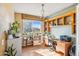 Sunlit office with hardwood floors, custom shelves, and a window offering pleasant views at 19602 E 63Rd Dr, Aurora, CO 80019