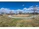 A beautiful park with an open green space surrounded by walking paths at 19602 E 63Rd Dr, Aurora, CO 80019