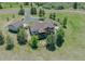 Aerial view of luxury home and property featuring a wooded area, firepit, and long drive at 3535 Medallion Rd, Castle Rock, CO 80104