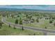 Stunning aerial view of a beautiful home with circular driveway, well-kept lawn, and mountain views in the background at 3535 Medallion Rd, Castle Rock, CO 80104