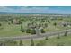 Expansive property featuring a home with mature trees, green lawns, and a long driveway in a serene, rural setting at 3535 Medallion Rd, Castle Rock, CO 80104