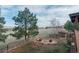 Landscaped backyard featuring a fire pit area, mature trees, and scenic views at 3535 Medallion Rd, Castle Rock, CO 80104