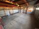 Unfinished basement featuring open shelving, concrete walls, and exposed ceiling beams at 3535 Medallion Rd, Castle Rock, CO 80104