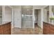 Bright bathroom showcasing wood cabinets, granite counters, and a modern, glass-enclosed shower at 3535 Medallion Rd, Castle Rock, CO 80104