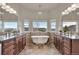 Luxury bathroom featuring dual vanities, a soaking tub, and a mountain view at 3535 Medallion Rd, Castle Rock, CO 80104