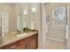 Stylish bathroom featuring wood cabinets, granite countertops, and well-placed lighting at 3535 Medallion Rd, Castle Rock, CO 80104