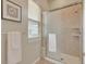 Bright bathroom with sliding glass shower door, and a sunny window at 3535 Medallion Rd, Castle Rock, CO 80104