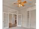 Bedroom featuring neutral colors, built-in shelving, and a ceiling fan at 3535 Medallion Rd, Castle Rock, CO 80104