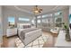 A bright bedroom with large windows, providing scenic views and tray ceilings with ceiling fan at 3535 Medallion Rd, Castle Rock, CO 80104