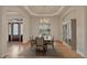 Charming dining room with tray ceiling, chandelier lighting, and decorative wood floors at 3535 Medallion Rd, Castle Rock, CO 80104